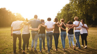 large group of friends tohether in a park having fun